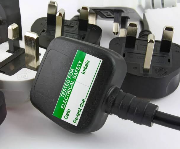 Portable appliance test label on a UK plug in Crewe